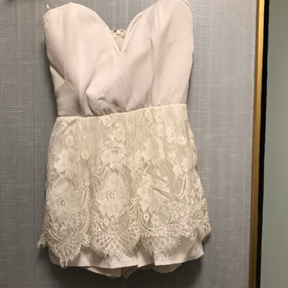Sleeveless lace peplum romper.